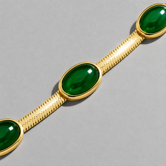 Cléo Necklace close up on a diagonal, hard light running along the flat snake chain