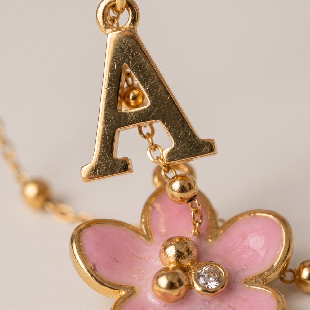 Amelie Initial Necklace - ARWELY macro detail of the letter charm and the pink flower