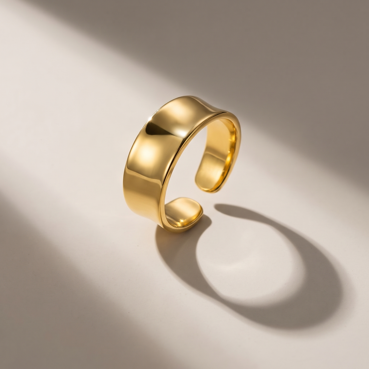 Bold Band Ring in gold finish - ARWELY editorial still life with a hard shadow