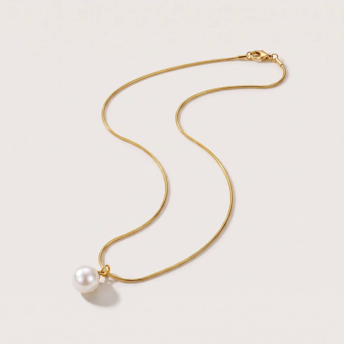 Luna Pearl Necklace in gold finish - ARWELY, full view on a grey studio background