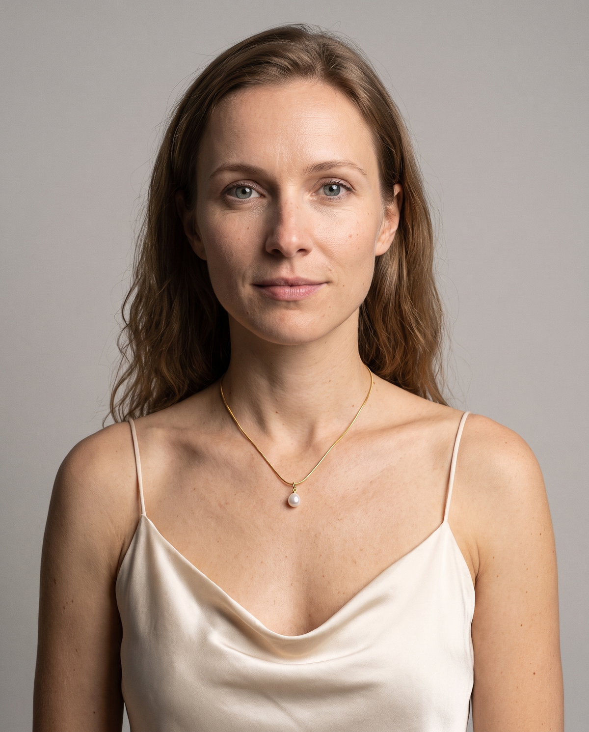 Luna Pearl Necklace in gold finish worn by a model - ARWELY studio portrait