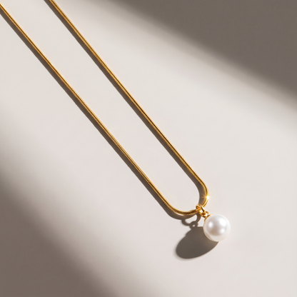 Luna Pearl Necklace in gold finish - ARWELY editorial still life with a hard shadow