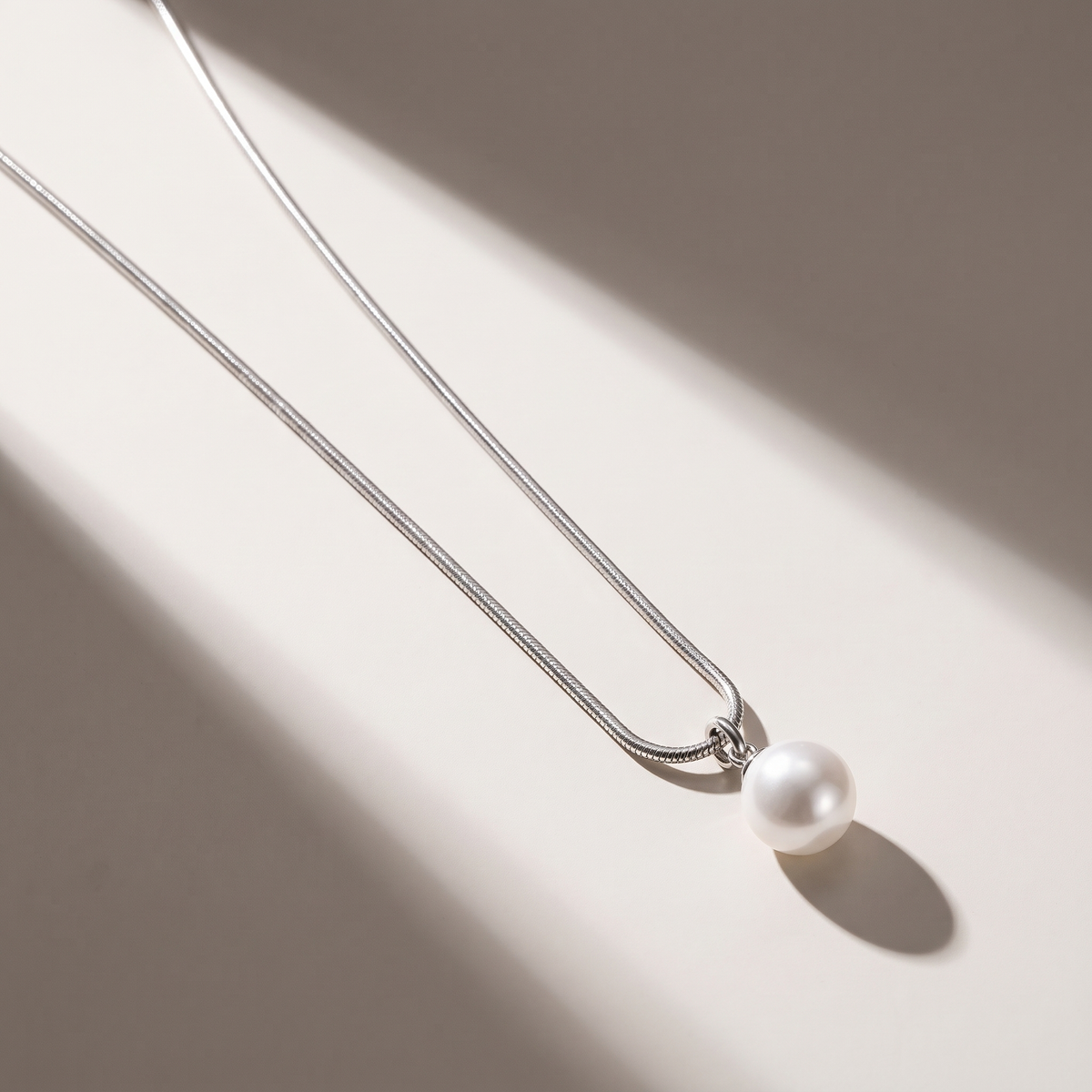 Luna Pearl Necklace in silver finish - ARWELY editorial still life with a hard shadow