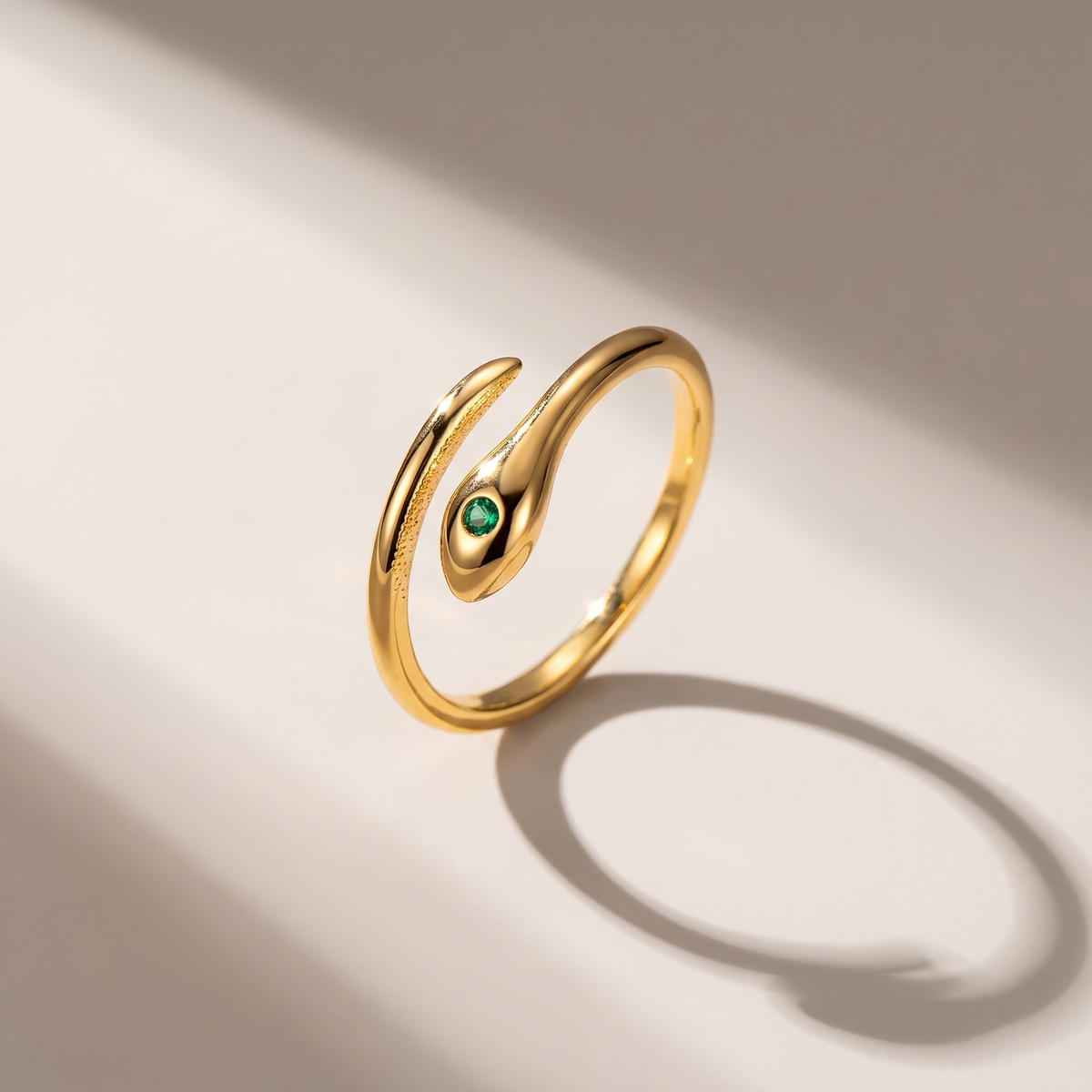 Serpent Ring in gold finish - ARWELY editorial still life with a hard shadow