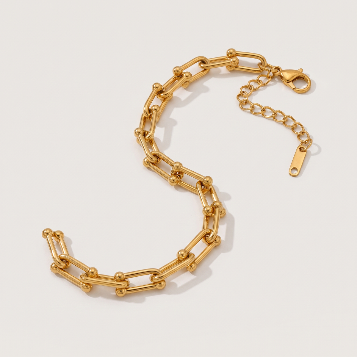 Vera Paperclip Bracelet in gold finish - ARWELY, full view on a grey studio background