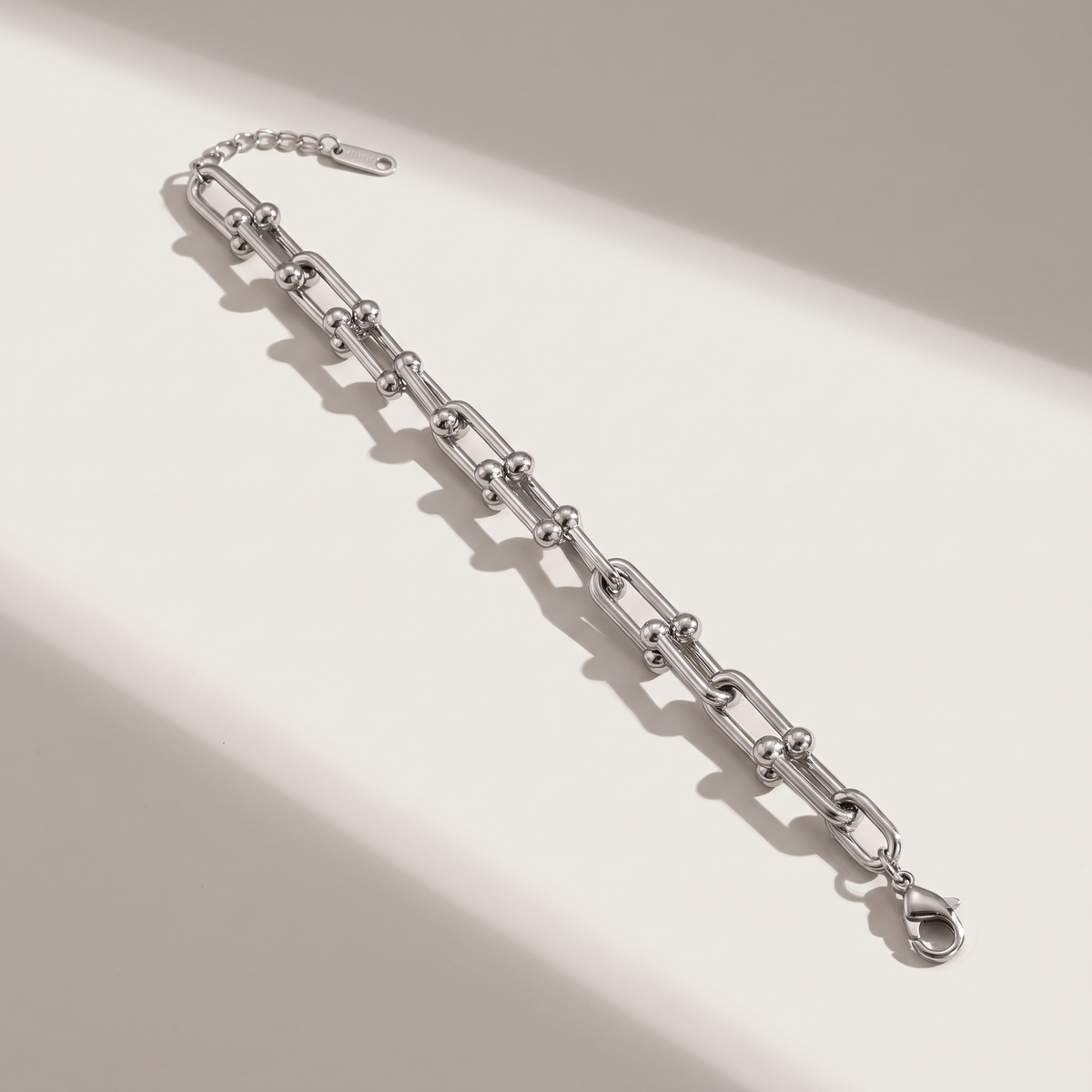 Vera Paperclip Bracelet in silver finish - ARWELY editorial still life with a hard shadow