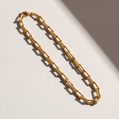 Vera Paperclip Necklace in gold finish - ARWELY editorial still life with a hard shadow