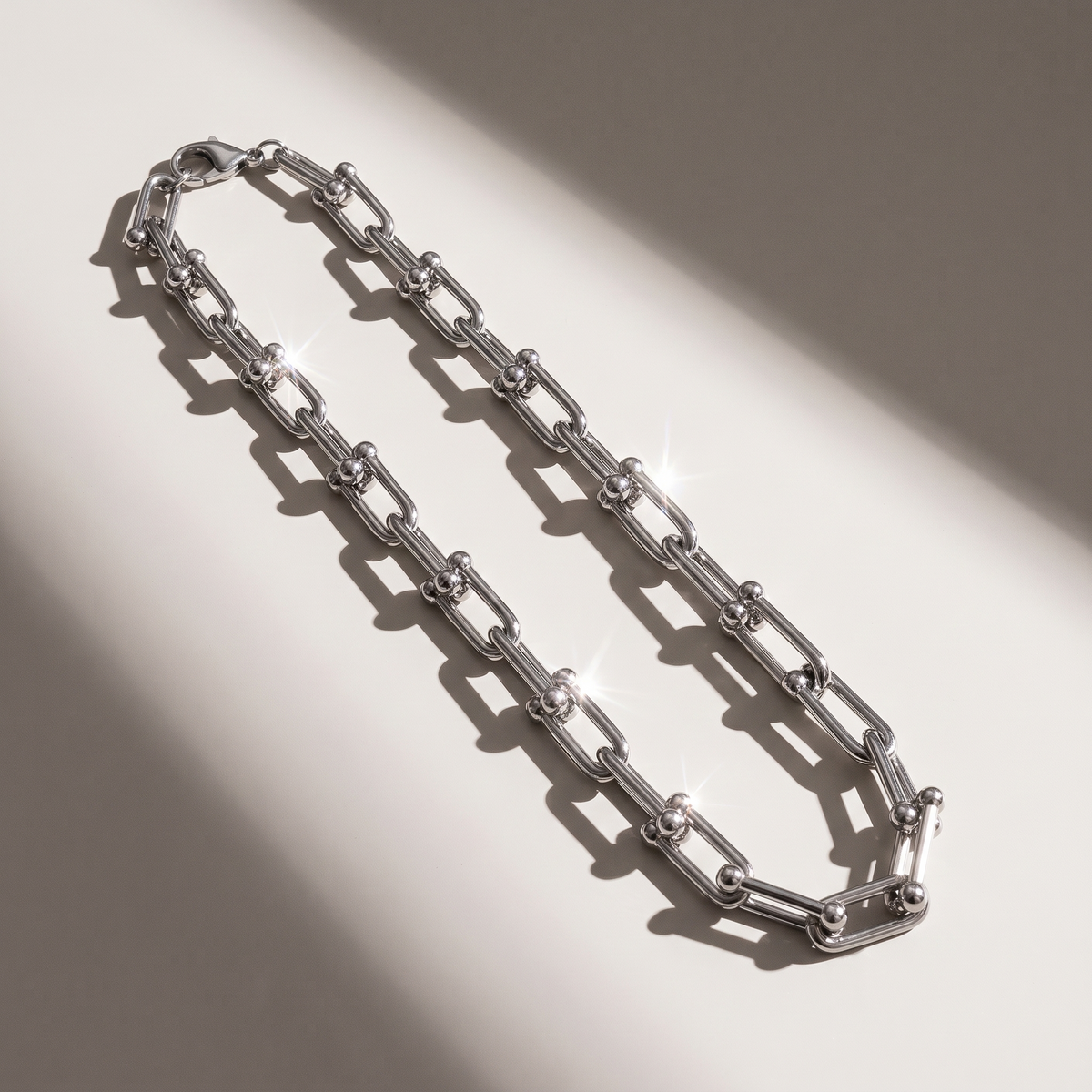 Vera Paperclip Necklace in silver finish - ARWELY editorial still life with a hard shadow