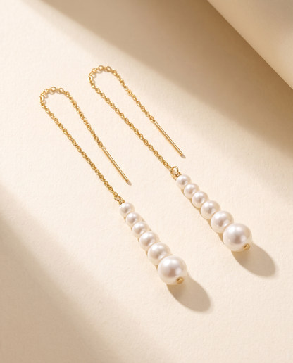 Cascade Pearl Threaders in gold - ARWELY, the pair laid flat showing the graduated line of pearls