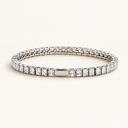 Rivière Tennis Bracelet in gold, square-cut zirconia set in a continuous line, on a warm off-white background