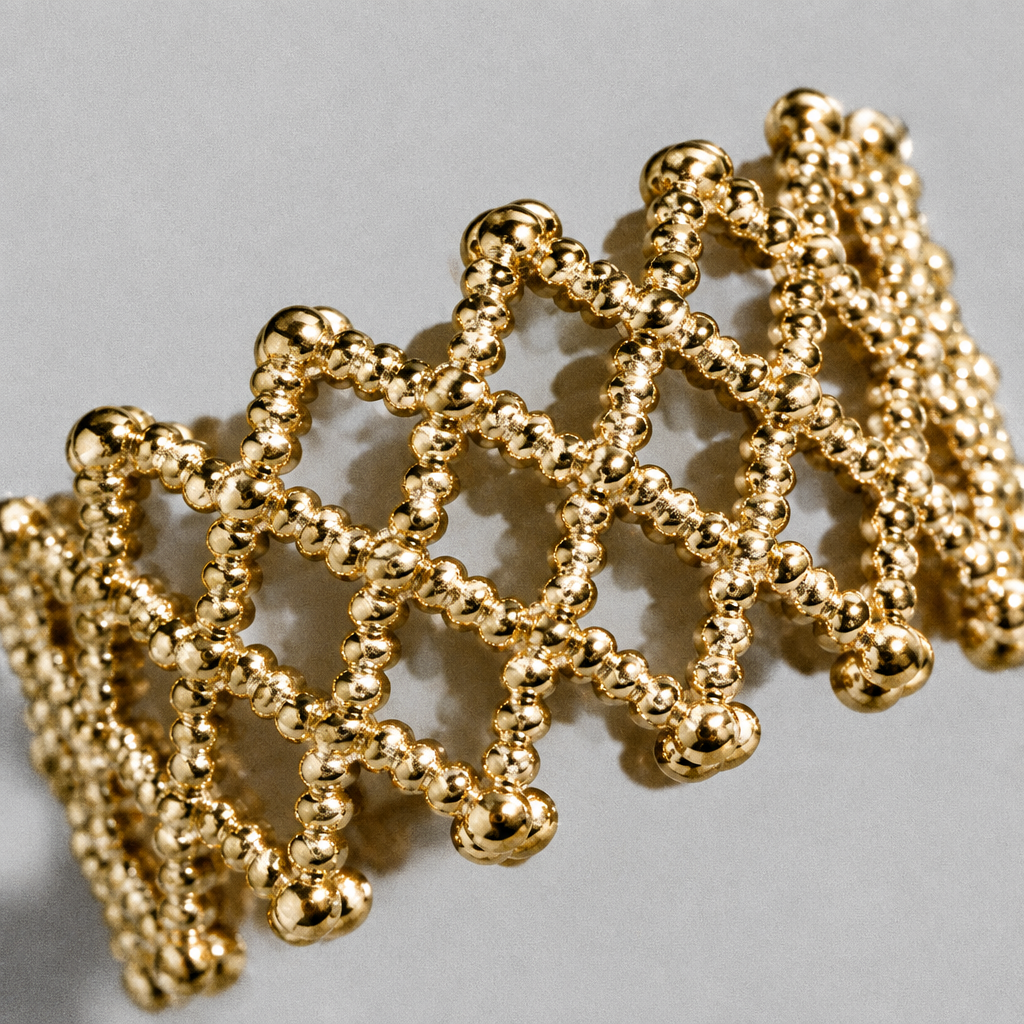 Tressa Open Ring close up on a diagonal, hard light across the beaded lattice