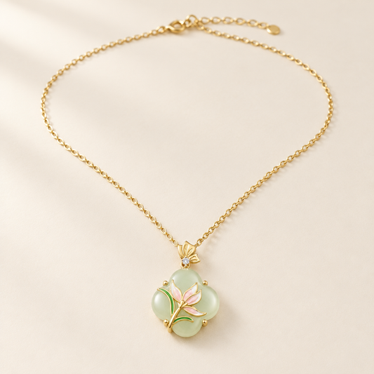 Magnolia Jade Necklace in gold — pale green jade blossom with a pink enamel flower