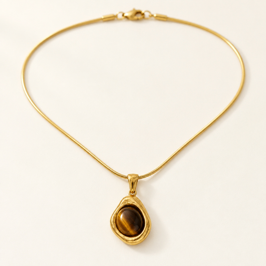Galet Pendant Necklace — tiger's eye in an uneven gold bezel on a snake chain