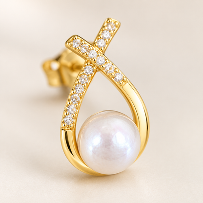 Close detail of one earring, the pearl and the pavé line