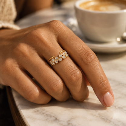 Halo Open Ring in zirconia worn on the hand at a café table