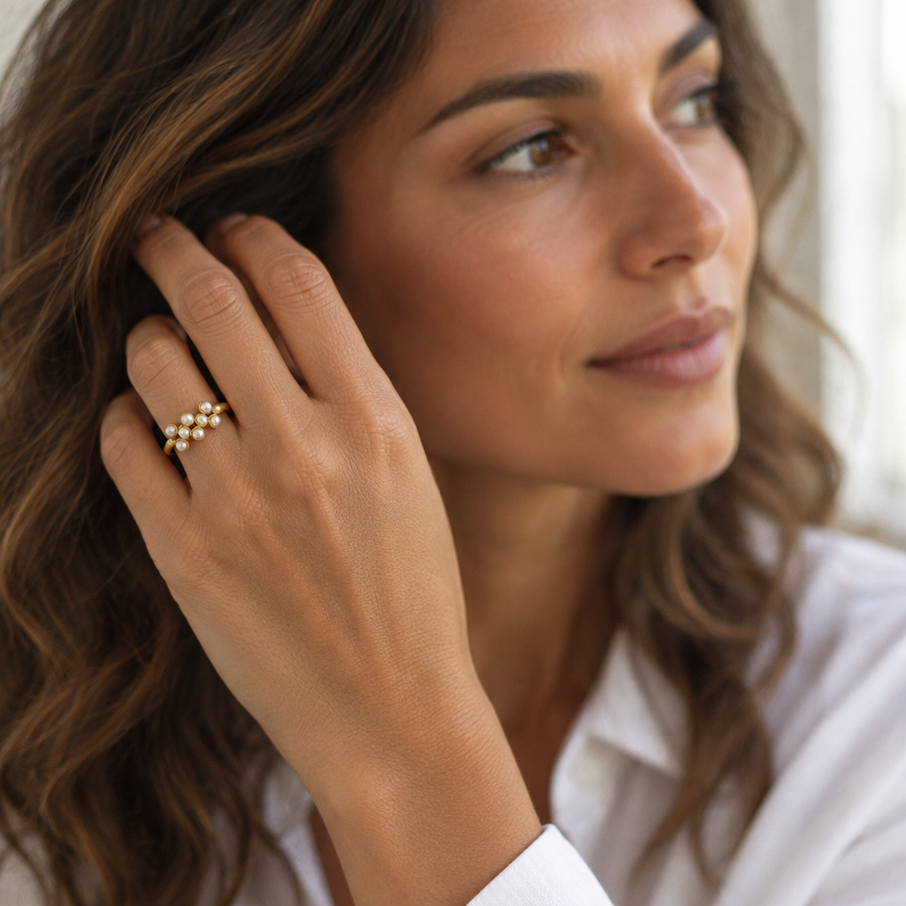 Halo Open Ring in imitation pearl worn, hand raised in window light